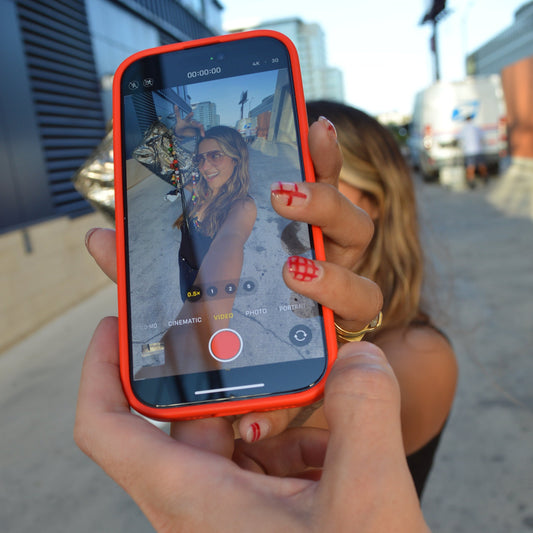 A cellphone screen taking a picture of a model showing new cherie limoe jewelry product.