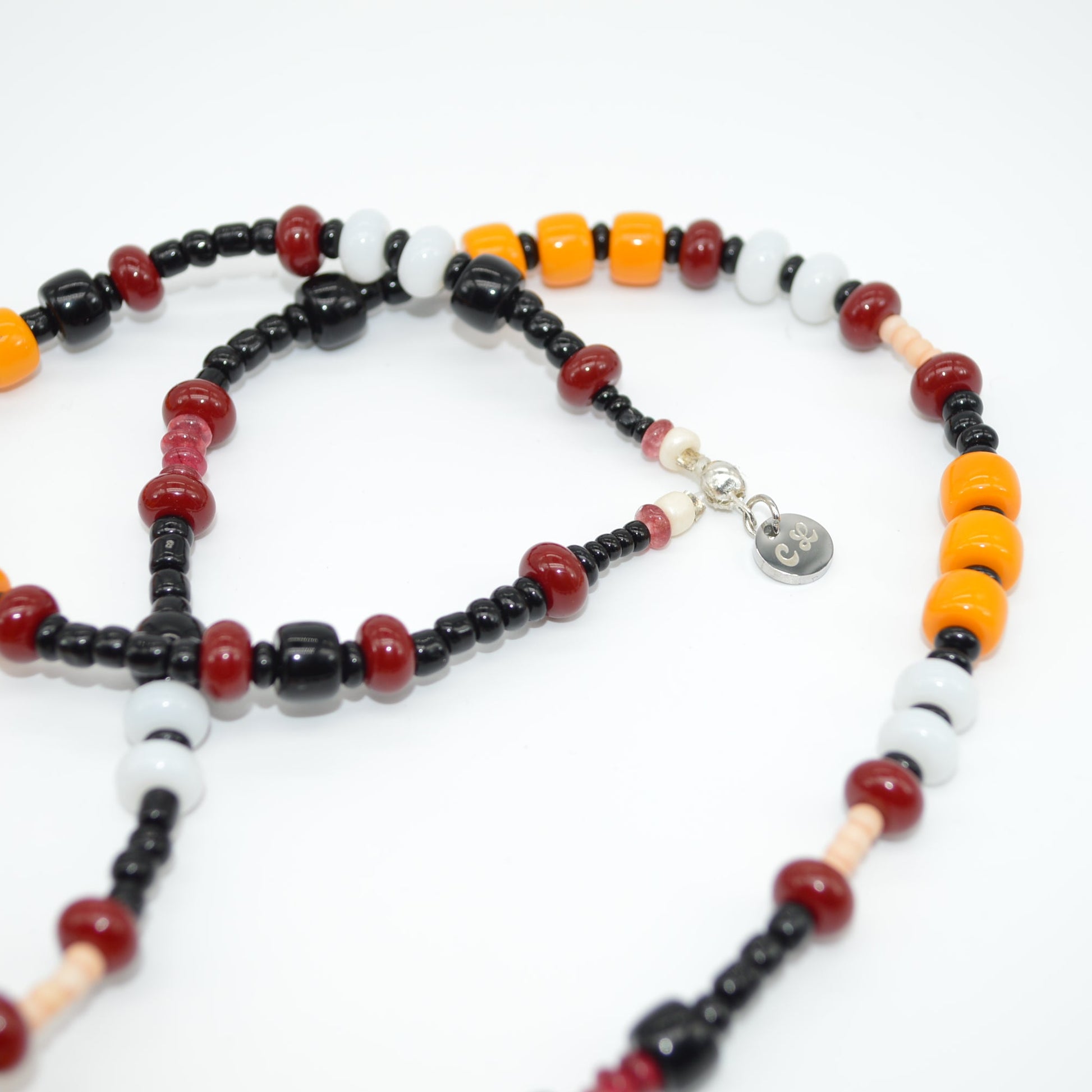 Necklace with multicolored beads on a white background