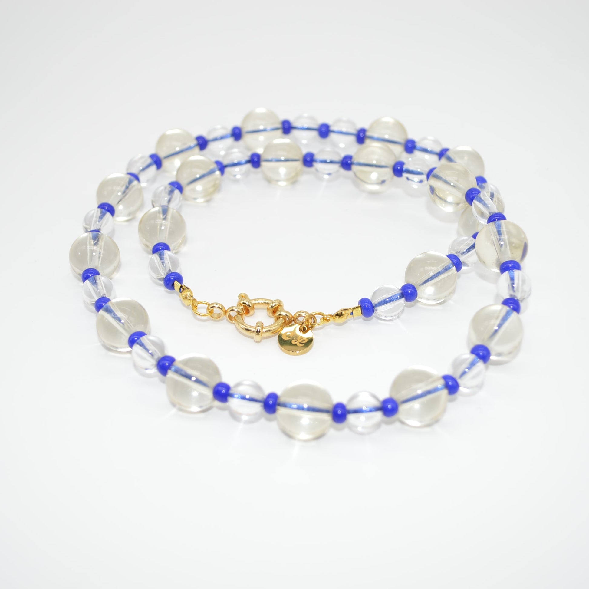 Beaded necklace with blue and gold accents on a white background