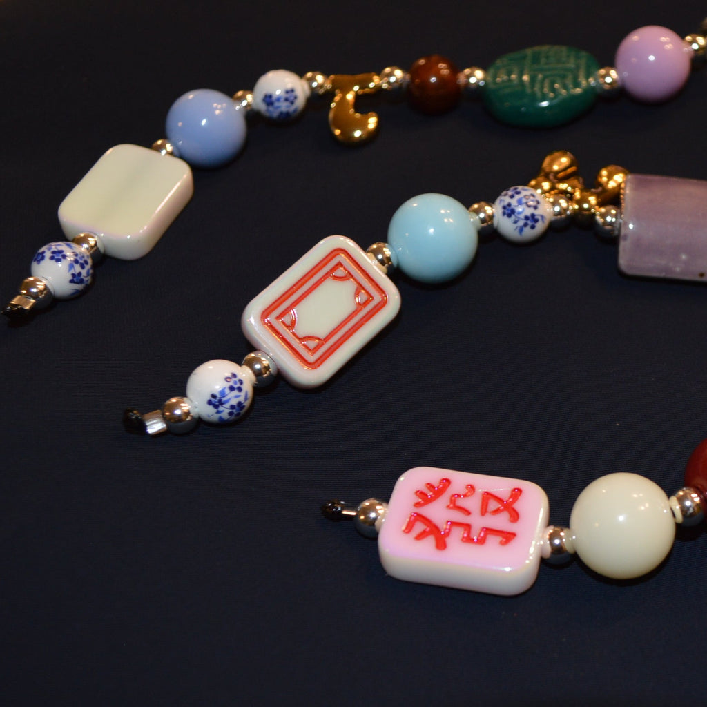 Colorful beaded necklace with various beads on a dark background