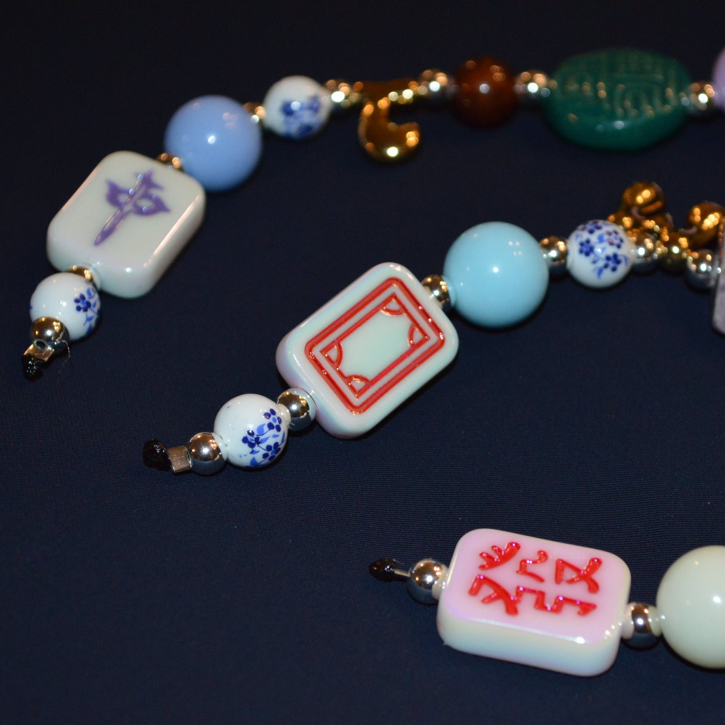 Colorful beaded necklace with various beads on a dark background