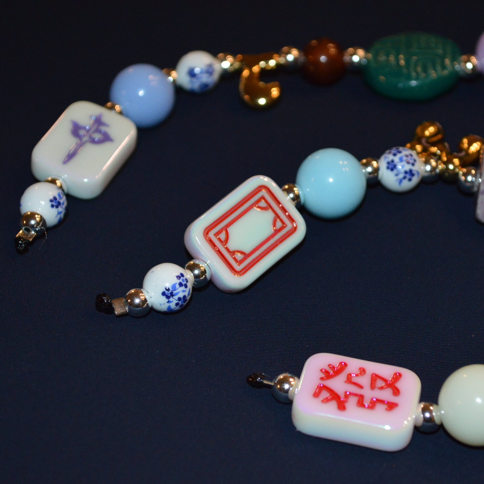 Colorful beaded necklace with various beads on a dark background