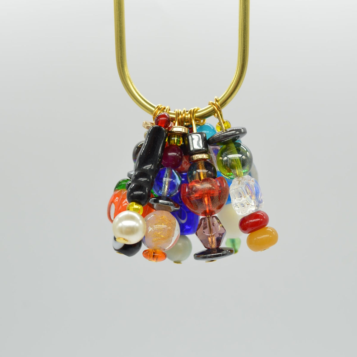 Decorative brooch with multicolored gemstones on a white background