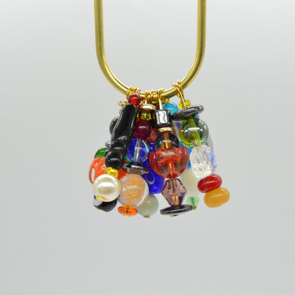 Decorative brooch with multicolored gemstones on a white background