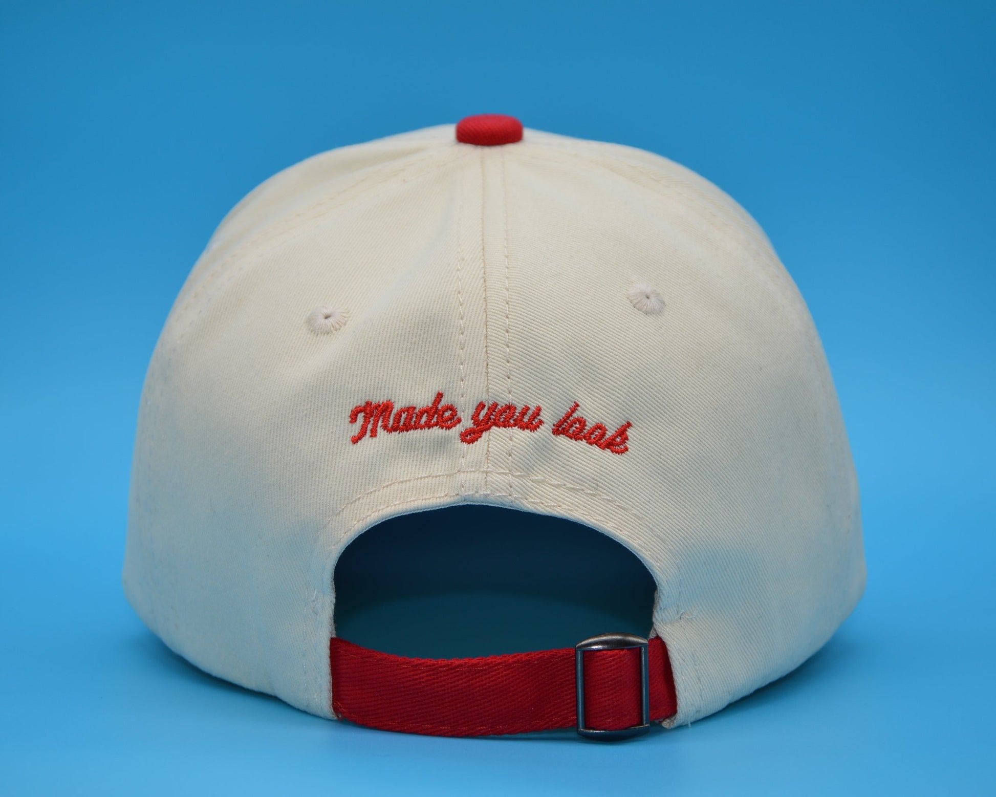 Beige cap with red text 'Made you look' on a blue background