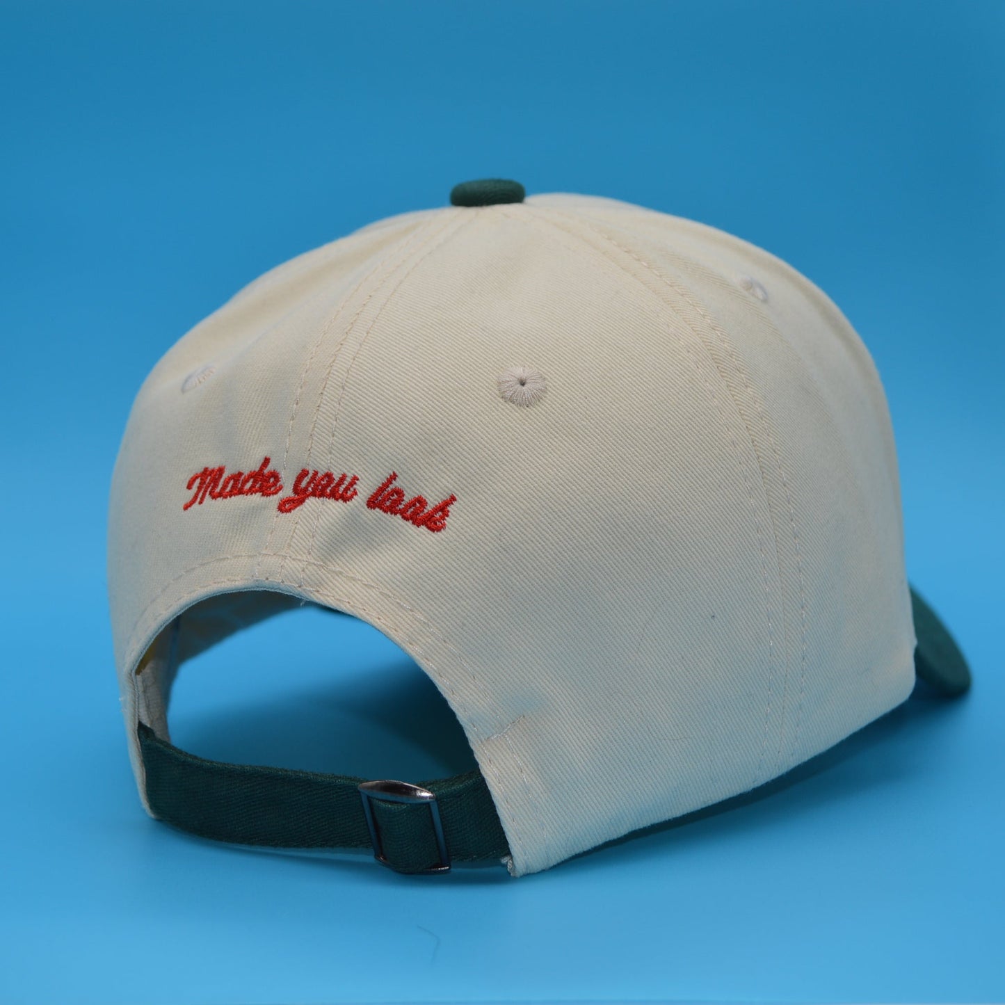 Beige cap with red text on a blue background