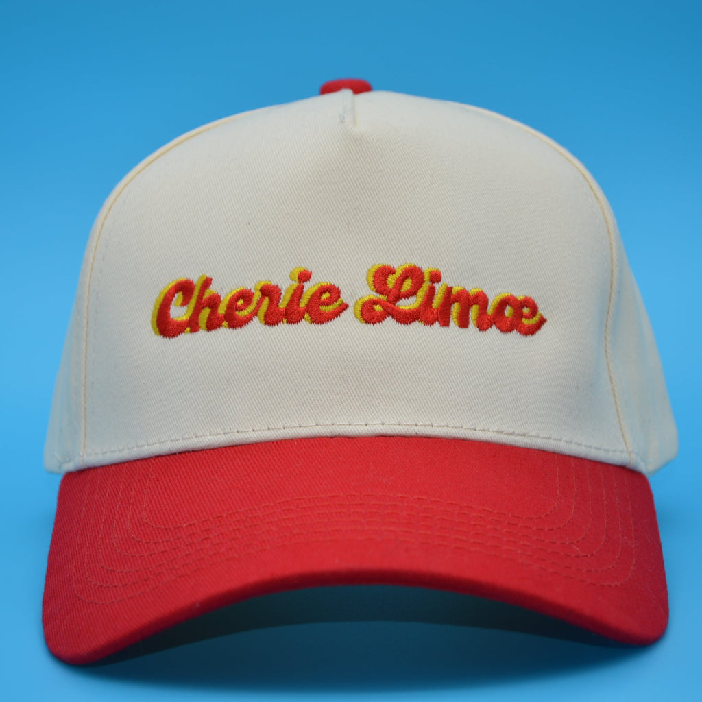 Beige and red cap with 'Cherie Lime' text on a blue background