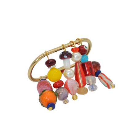 Colorful beaded brooch with a gold clasp on a white background