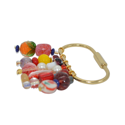 Colorful beaded keychain with a gold clasp on a white background