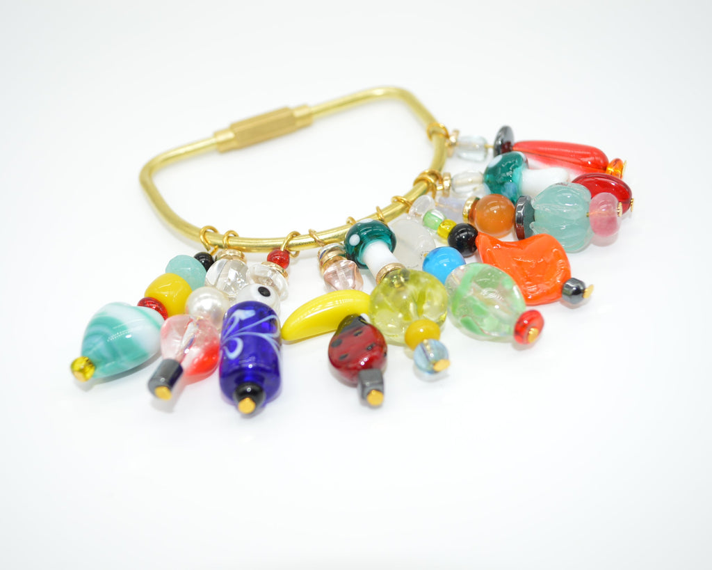 Colorful beaded clip with gold clasp on a white background