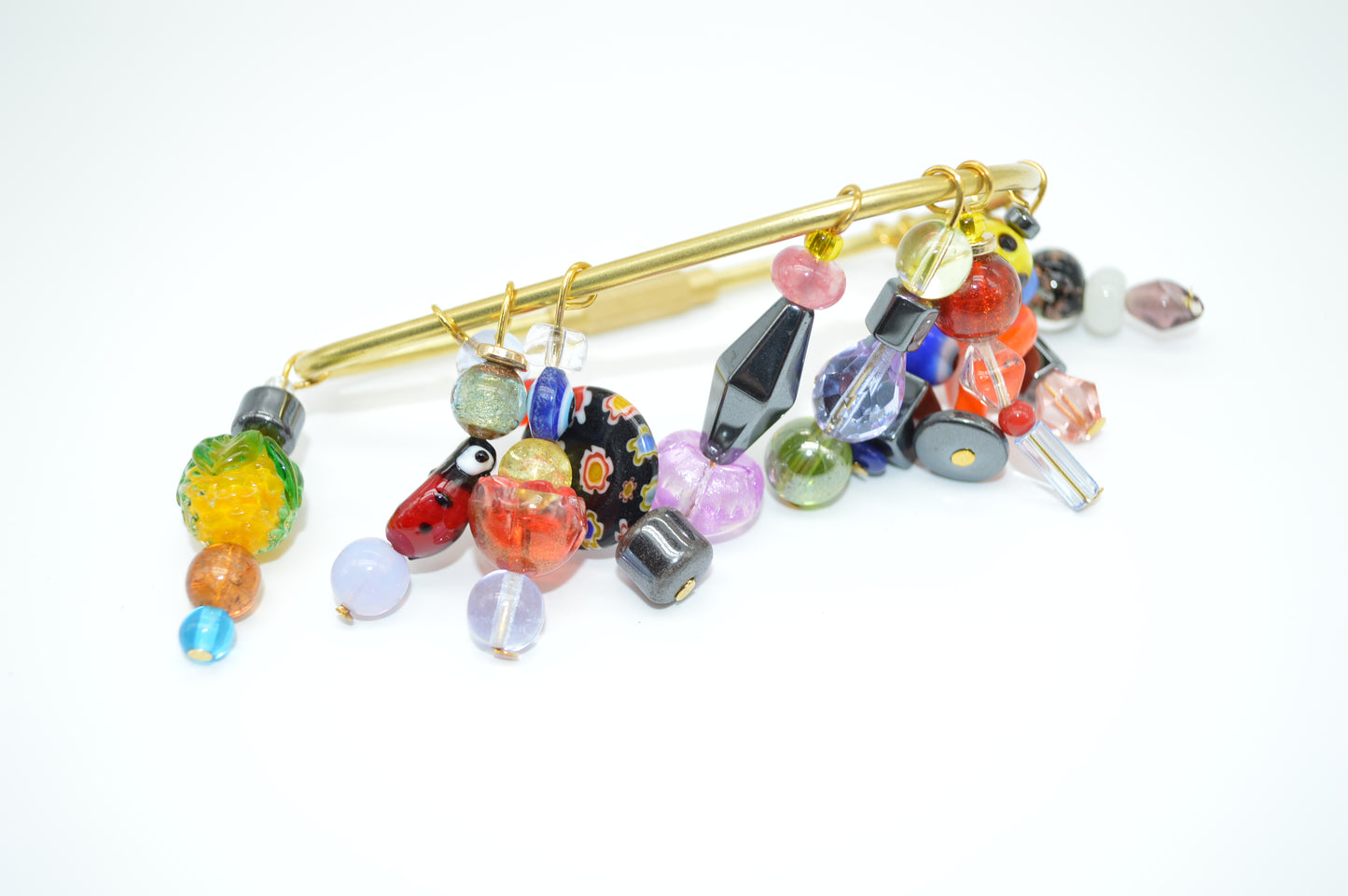 Colorful glass bead brooch on a white background