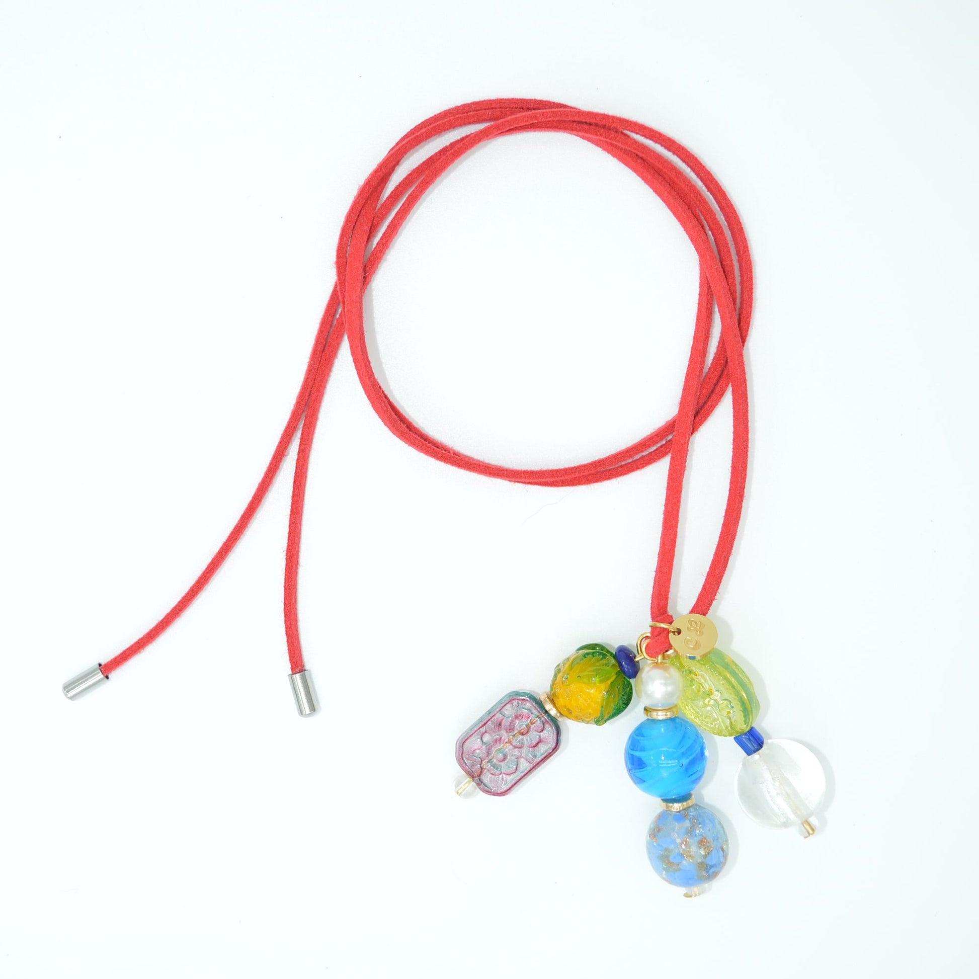 Red lanyard with colorful charms on a white background