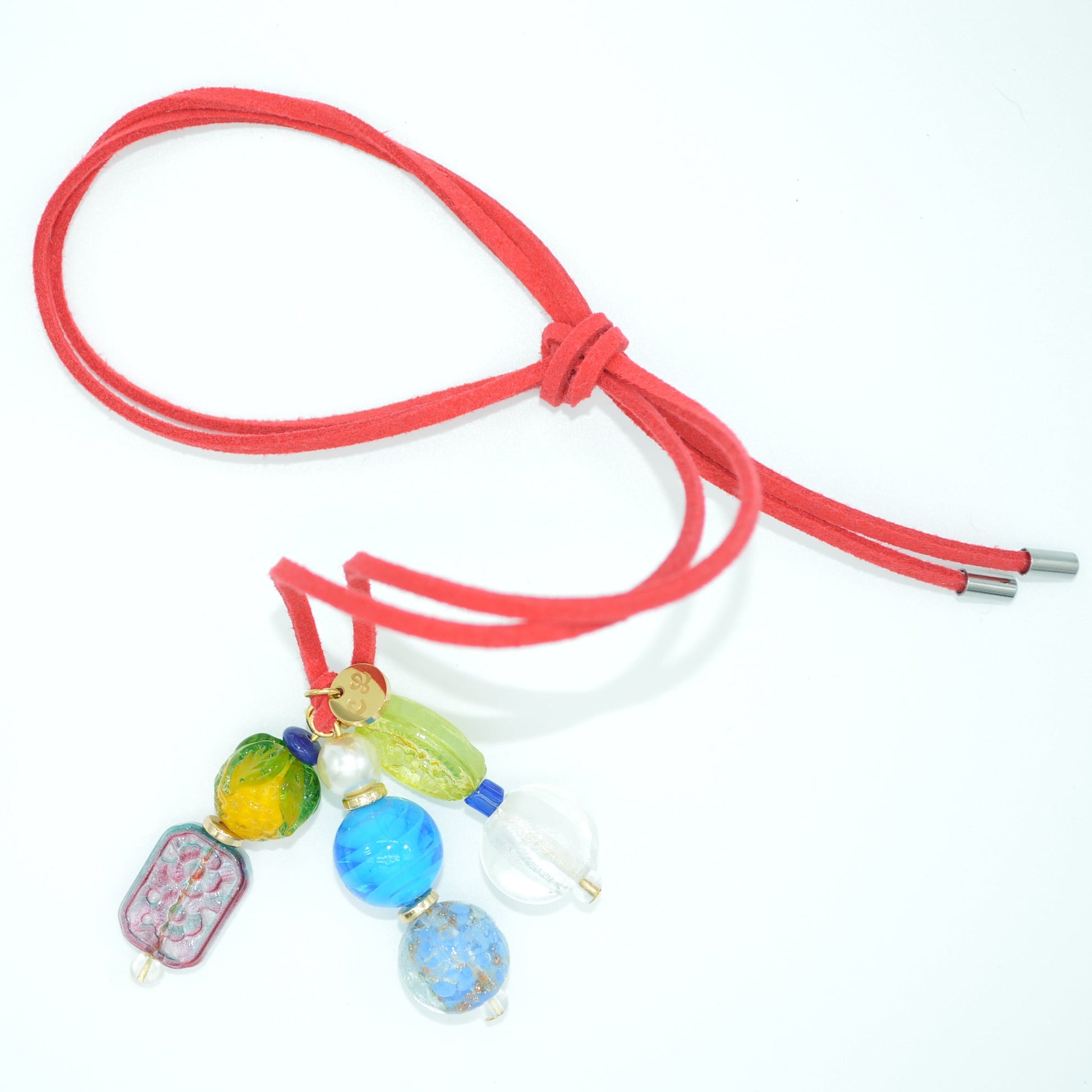 Neon pink cord with colorful beads on a white background