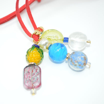 Colorful beaded necklace with various beads on a white background