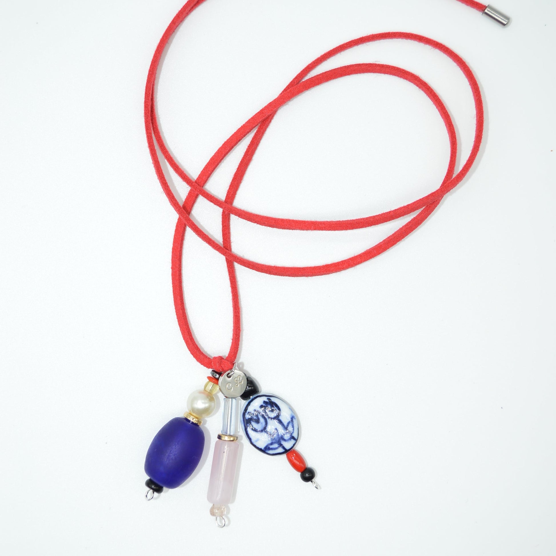 Red lanyard with a blue and white decorative element on a white background