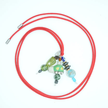 Red cord with colorful beads on a white background