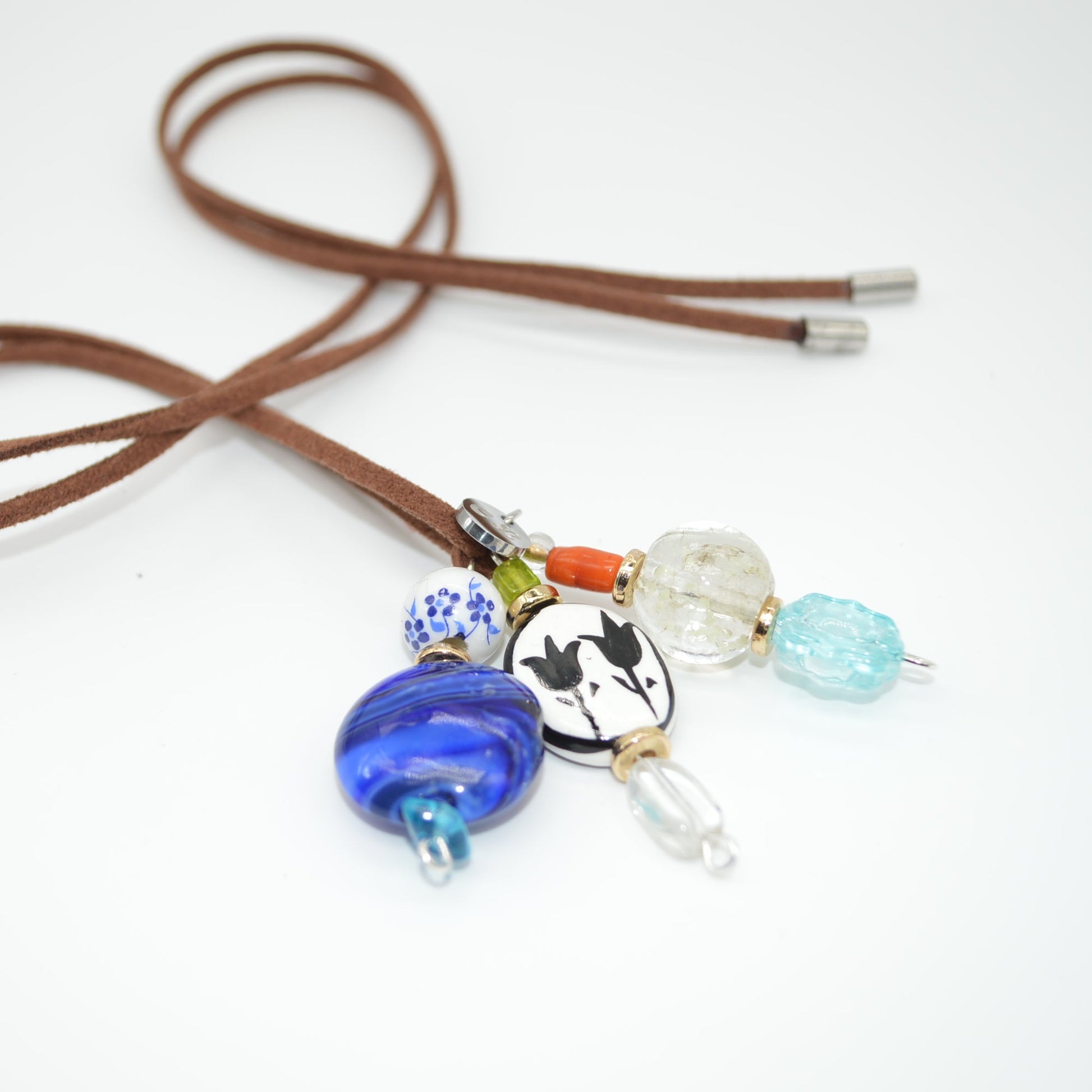Brown cord with colorful beads on a white background
