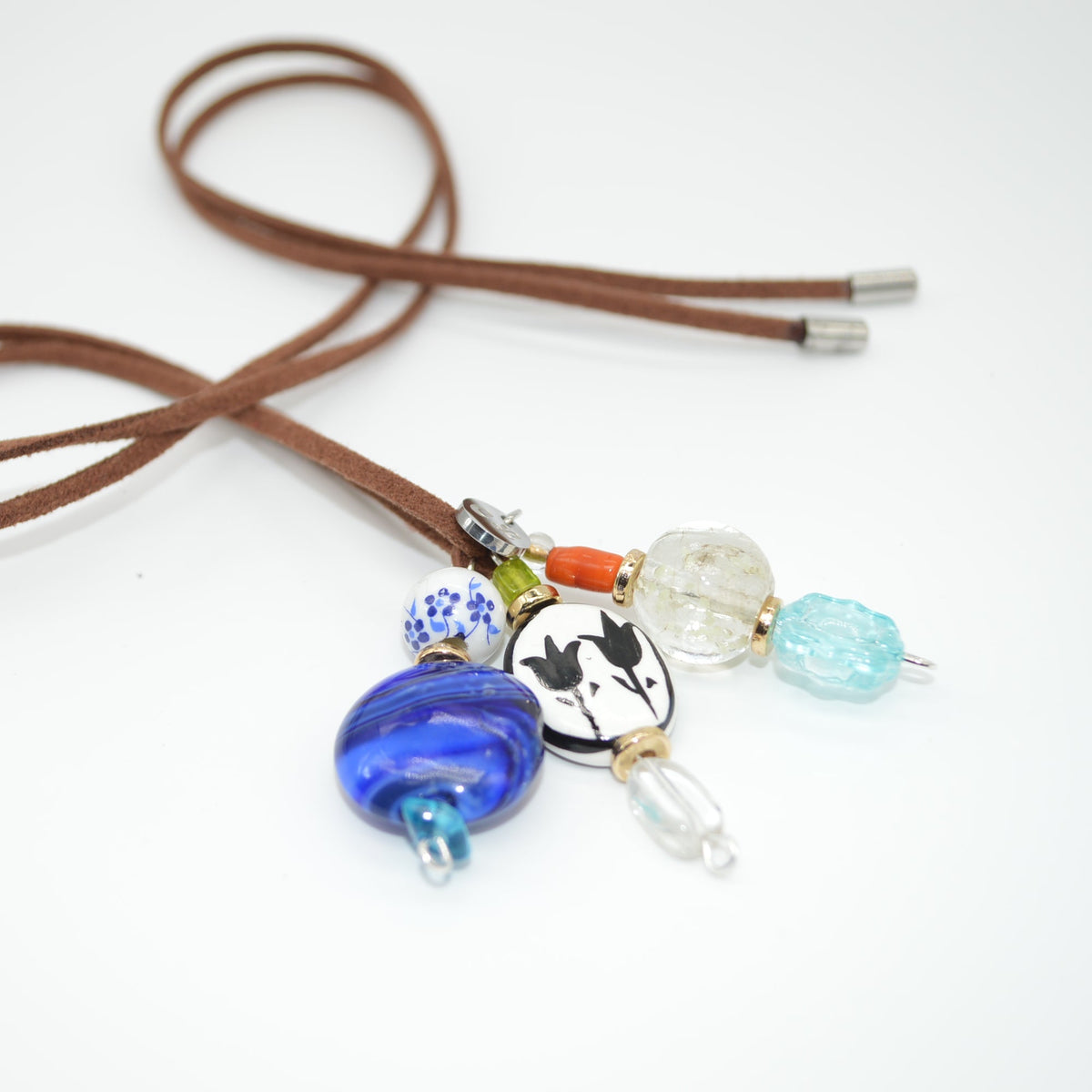 Brown cord with colorful beads on a white background