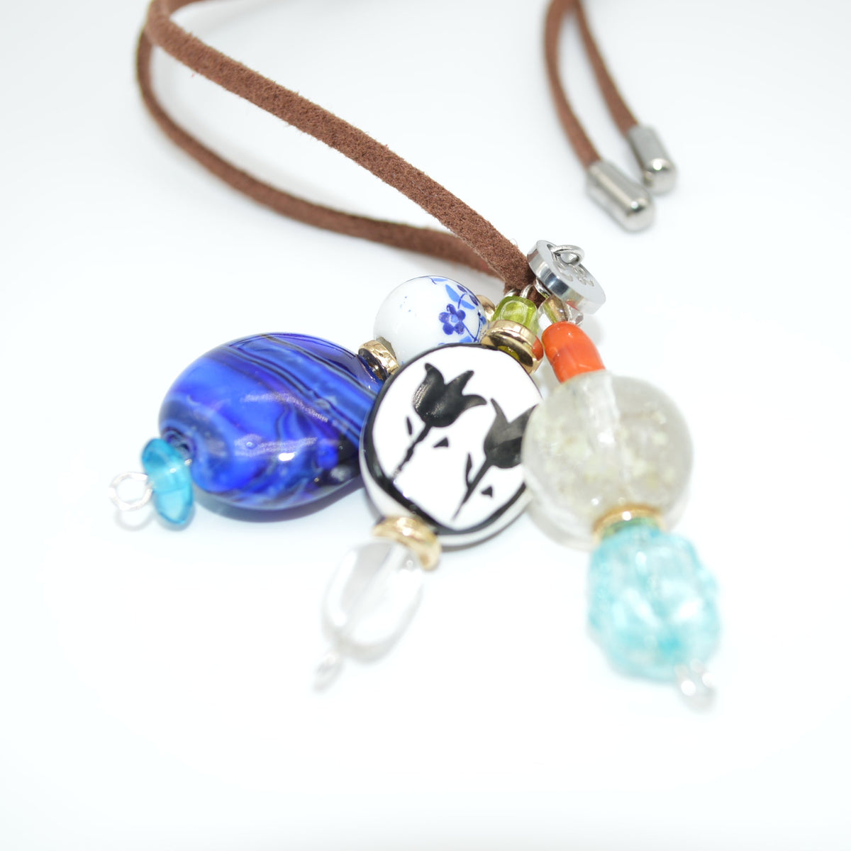 Necklace with blue, white, and turquoise beads on a white background