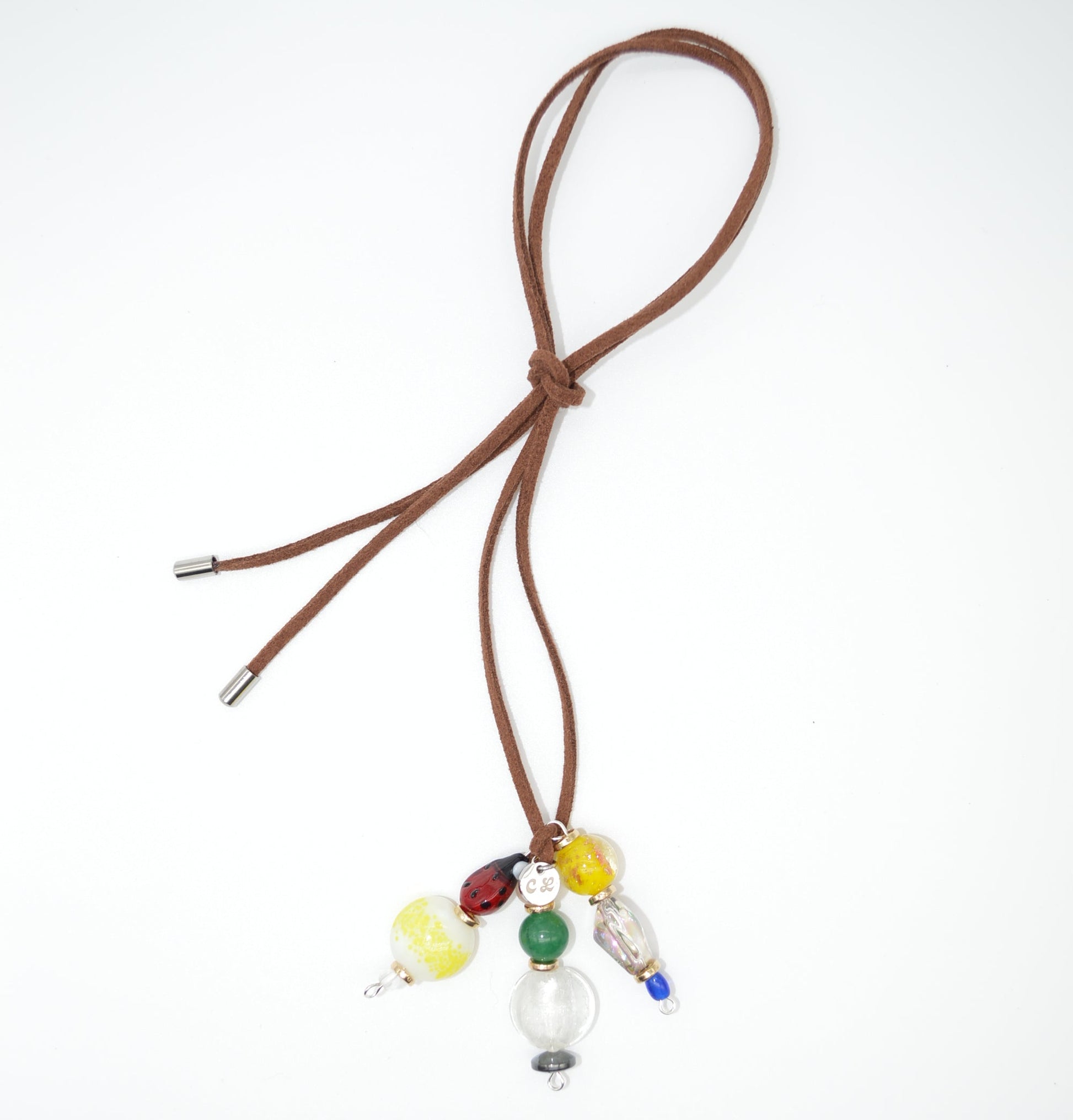 Brown cord with colorful beads on a white background