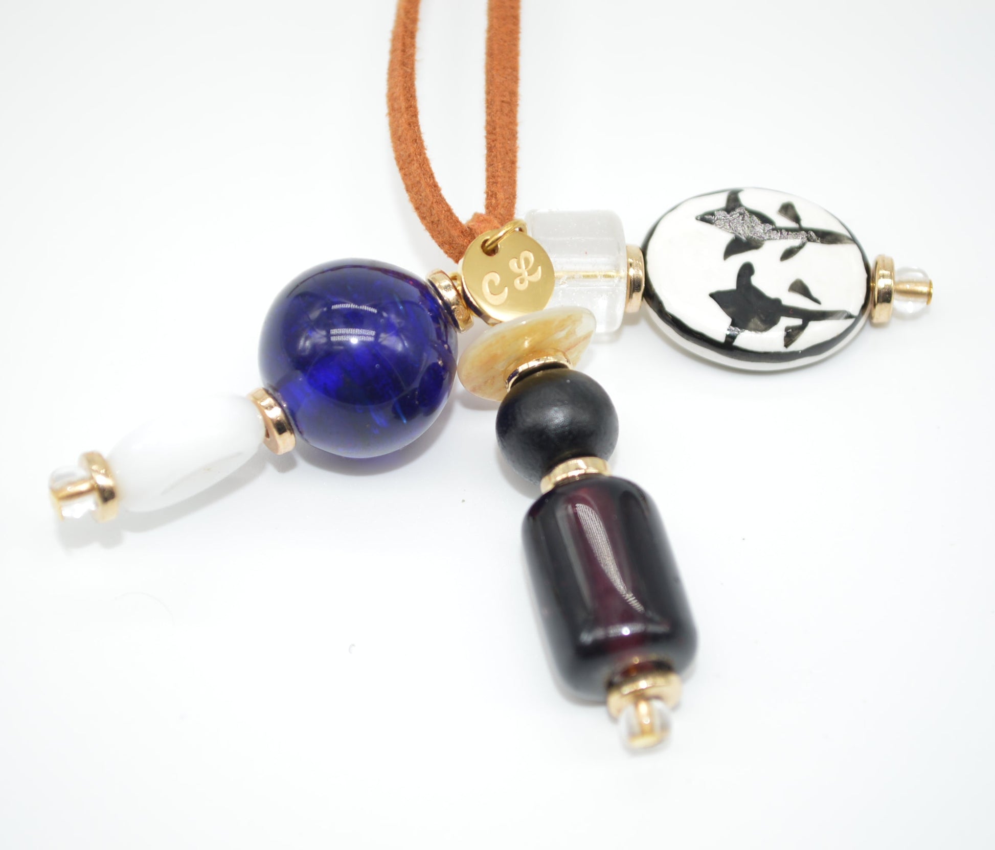 Necklace with blue, black, and gold beads on a white background