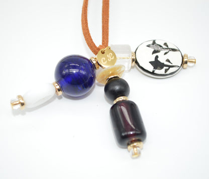 Necklace with blue, black, and gold beads on a white background