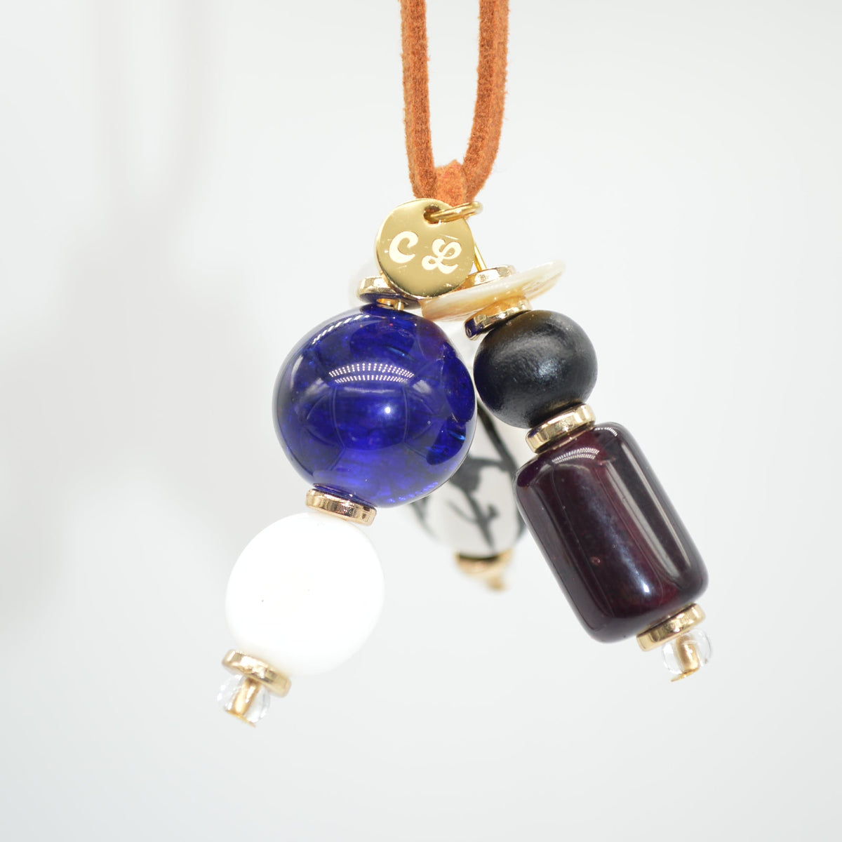 Necklace with blue, black, and red beads on a white background