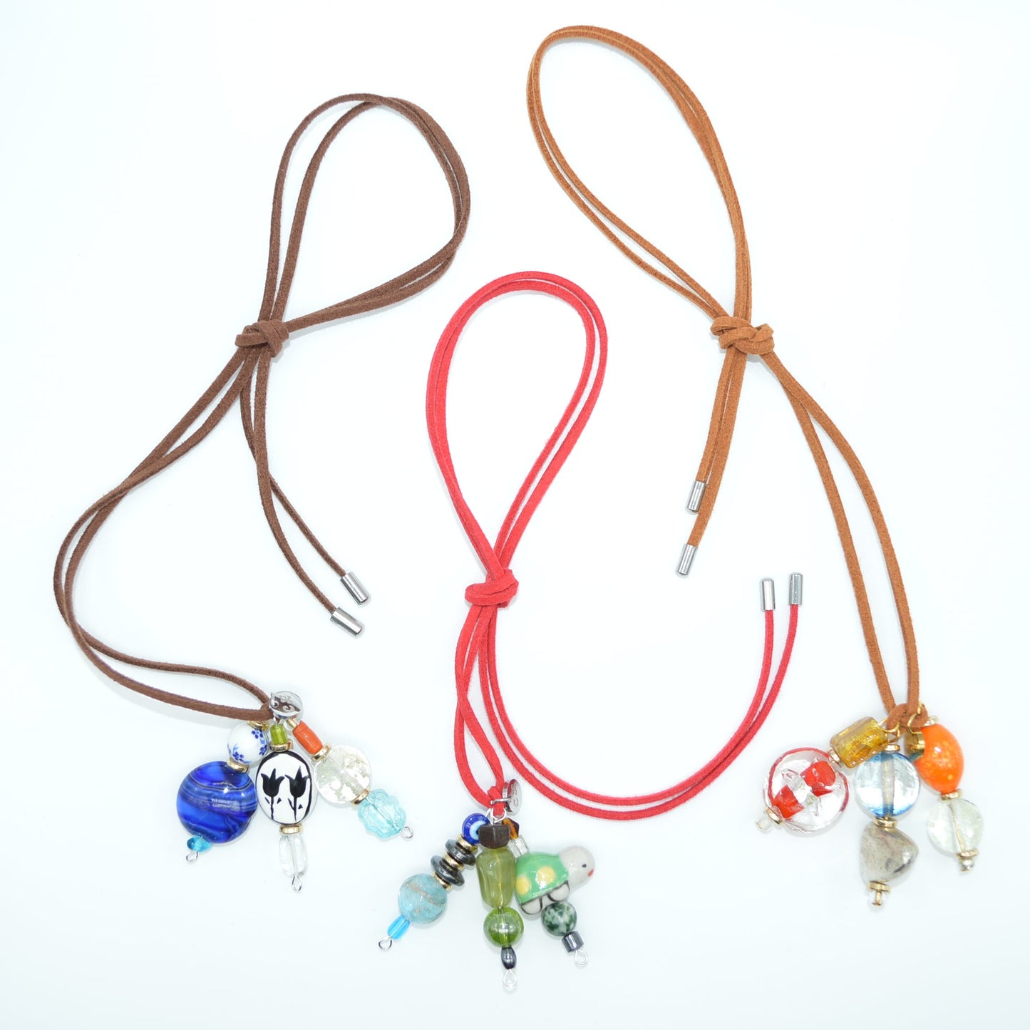 Three colorful necklaces with beads on a white background