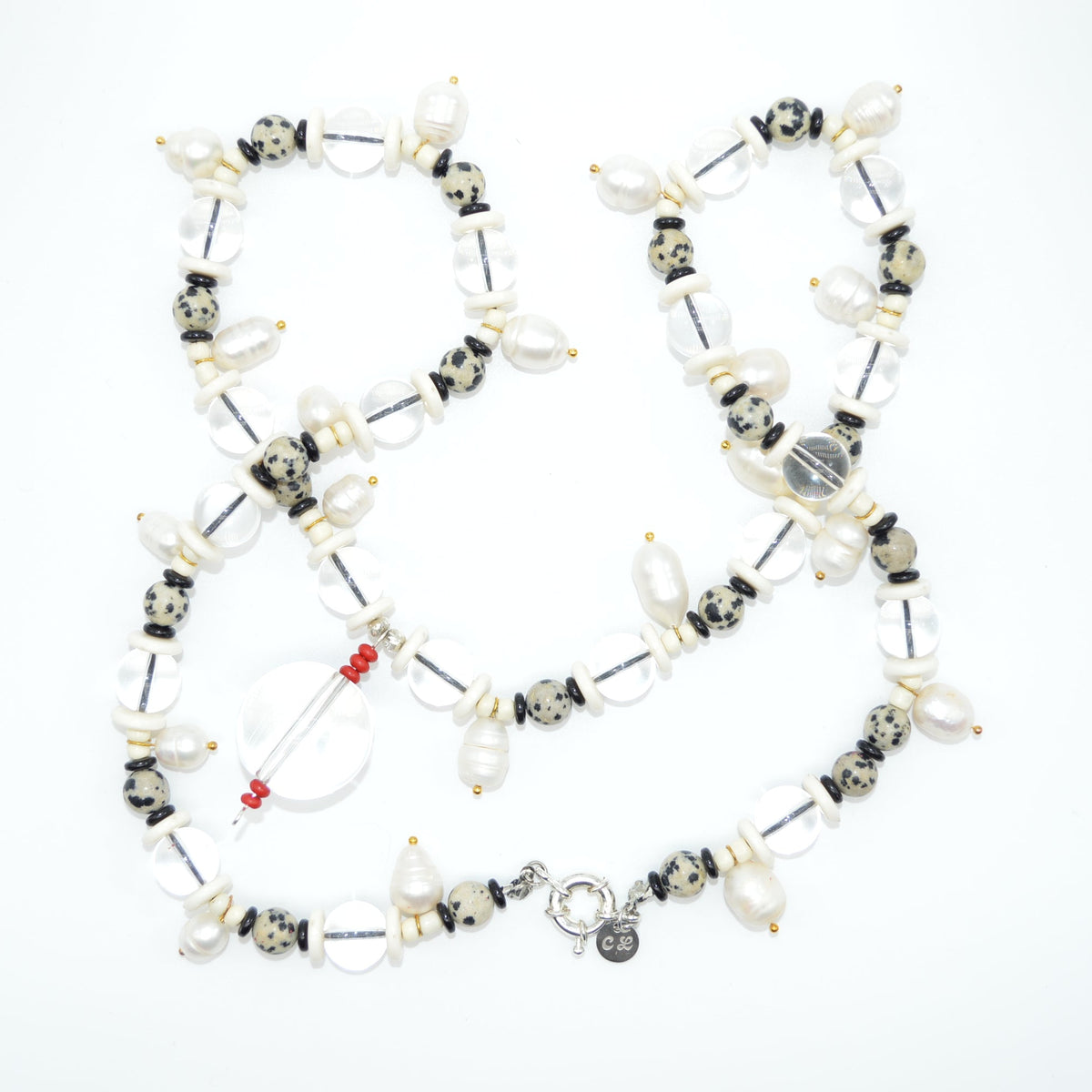 Necklace with various beads and charms on a white background