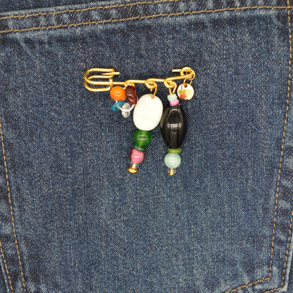 Colorful beaded keychain on a blue denim pocket