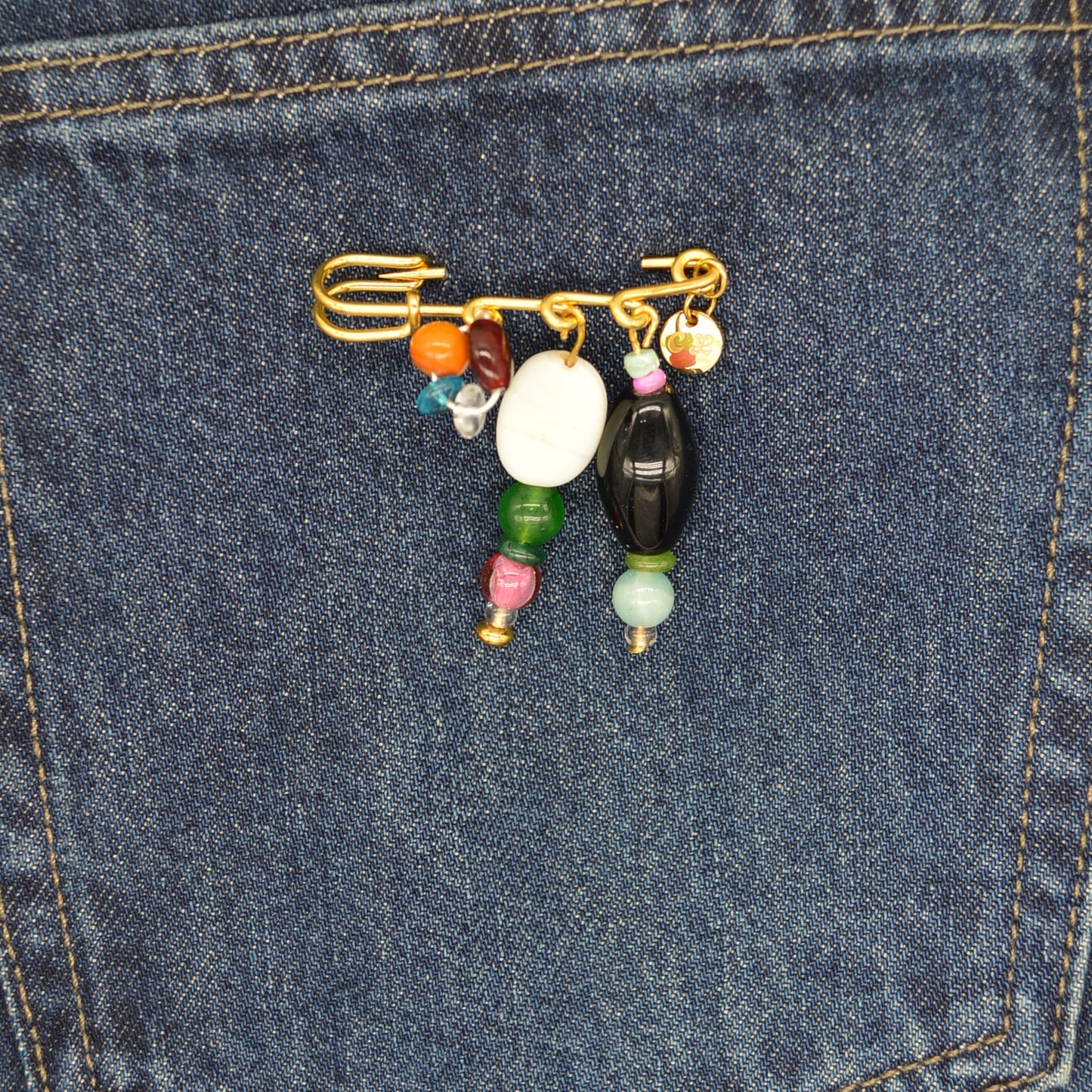 Colorful beaded keychain on a blue denim pocket