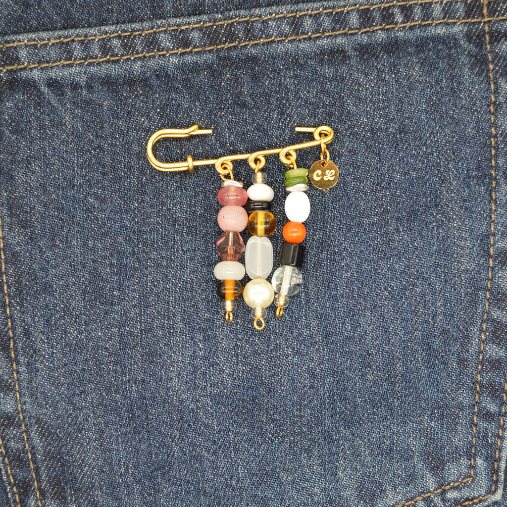 Colorful beaded keychain attached to a blue denim pocket.