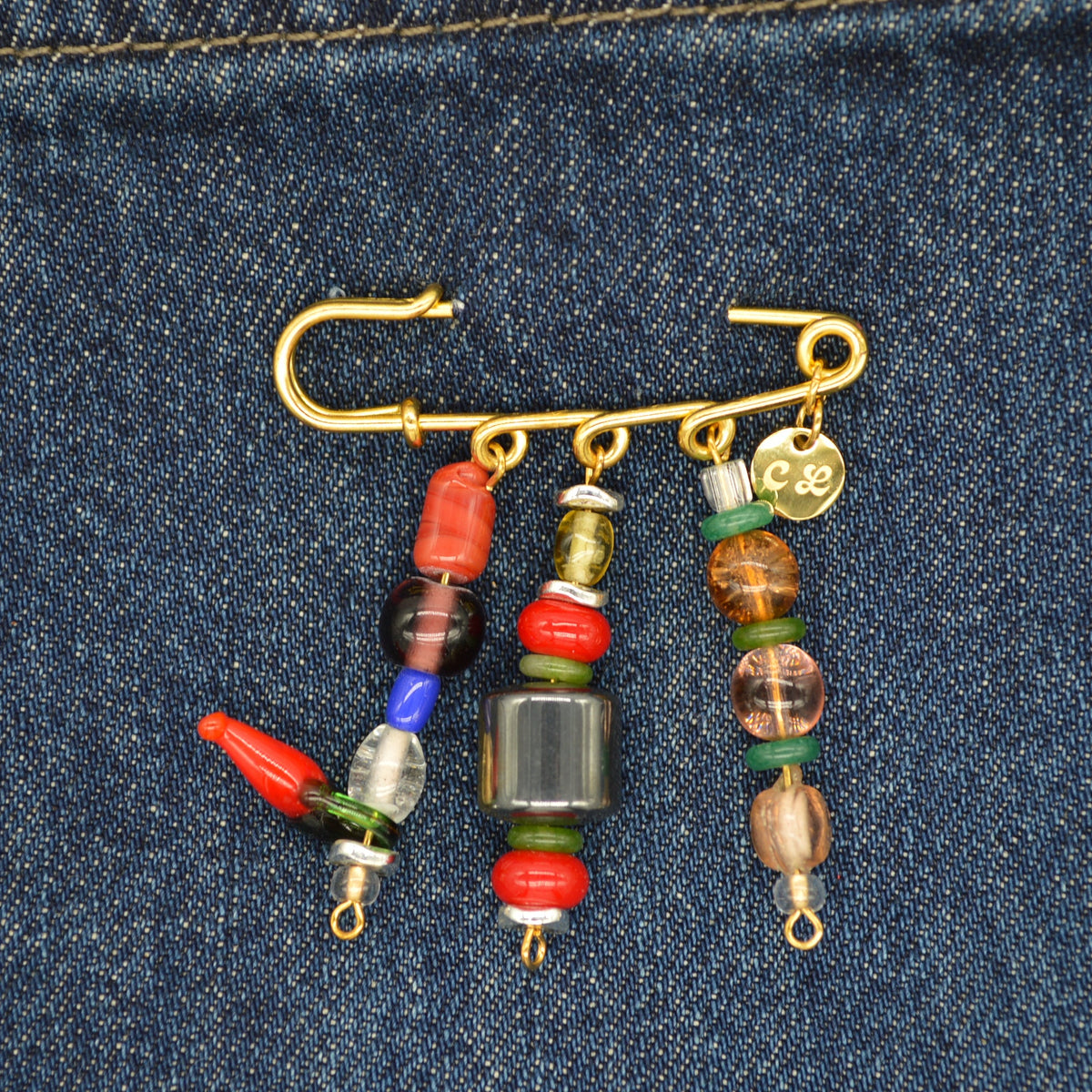 Fishing hook with colorful beads on a denim background