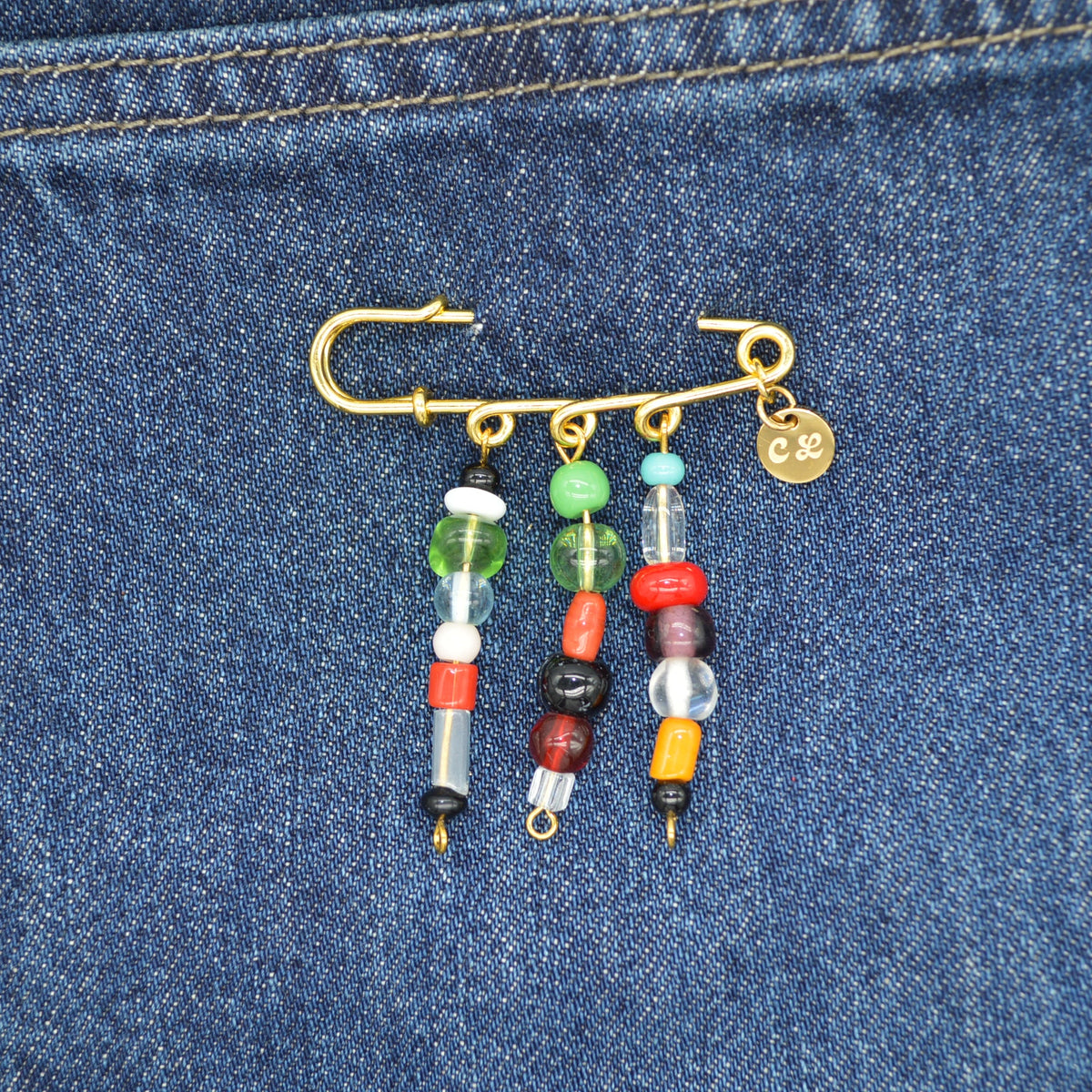 Colorful beaded keychain attached to a blue denim fabric