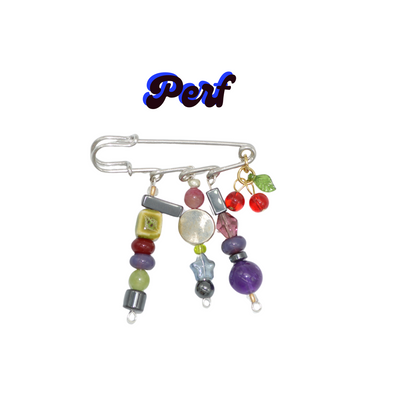 Colorful beaded brooch with a safety pin on a white background