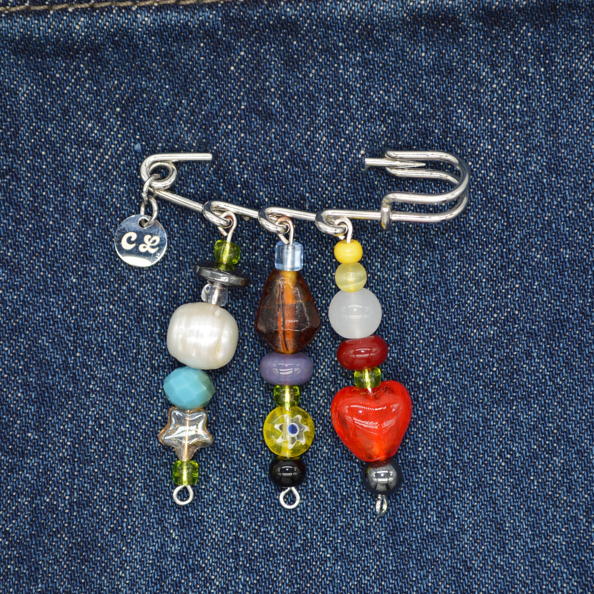 Colorful beaded earrings on a denim background