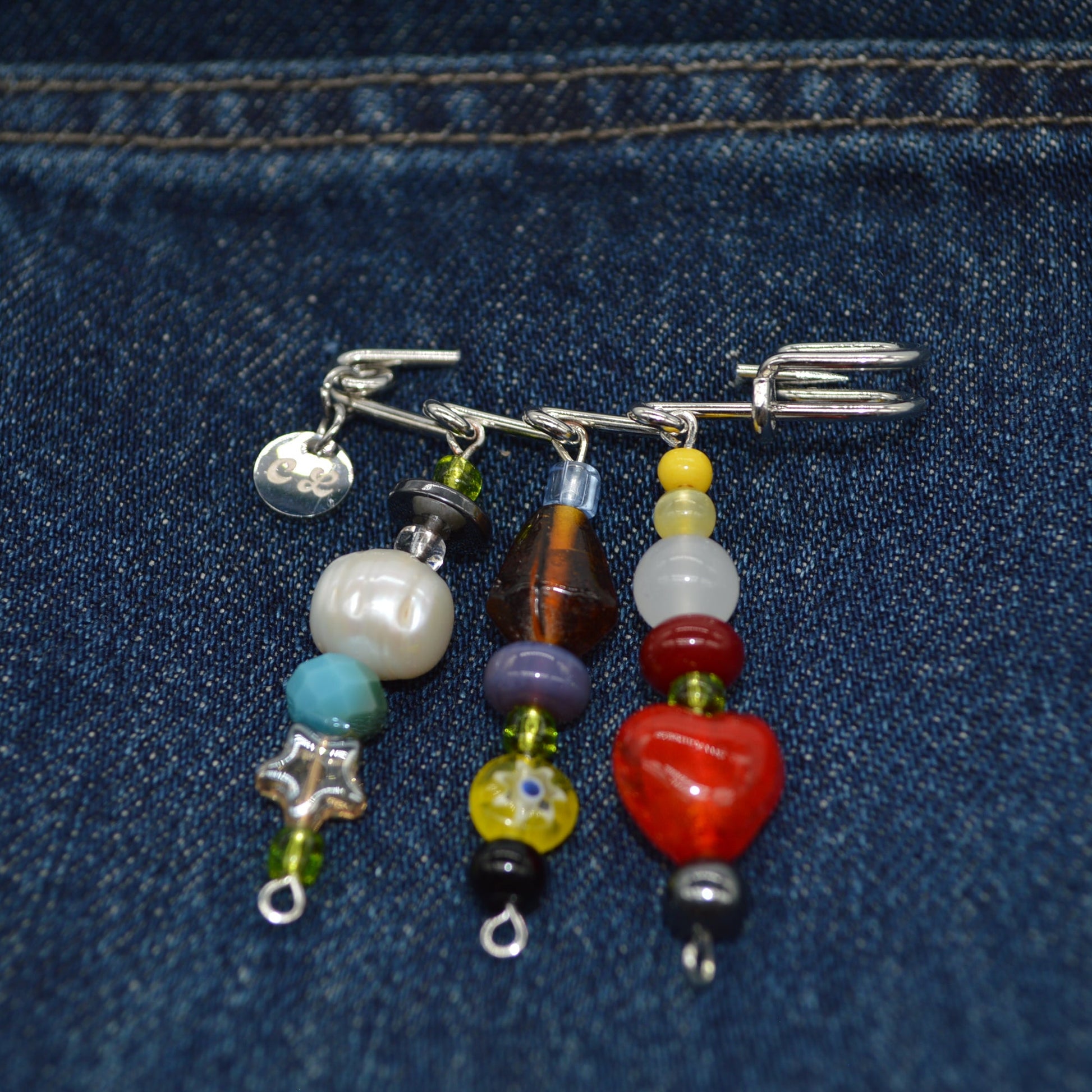 Colorful beaded charm on a blue denim background