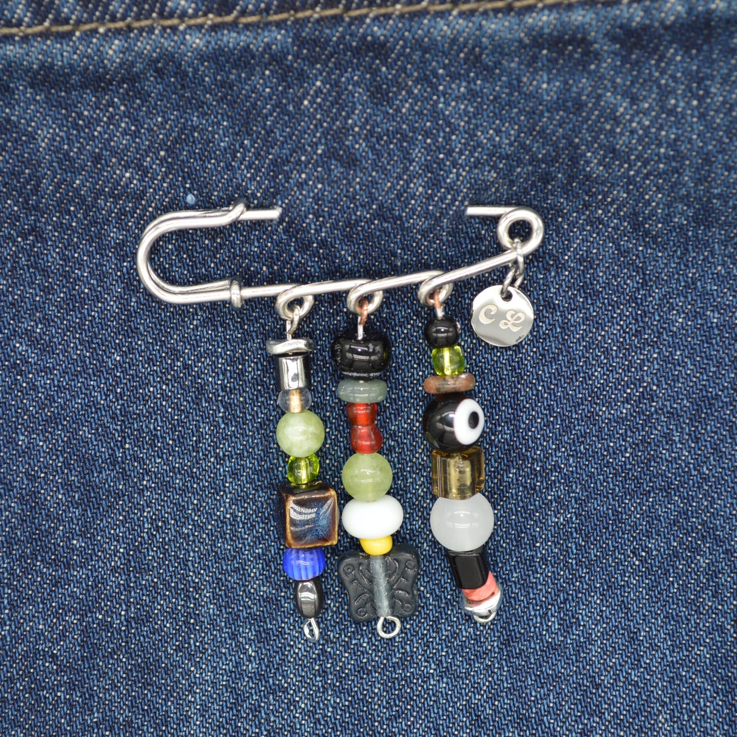 Keychain with beads and charms on a denim background