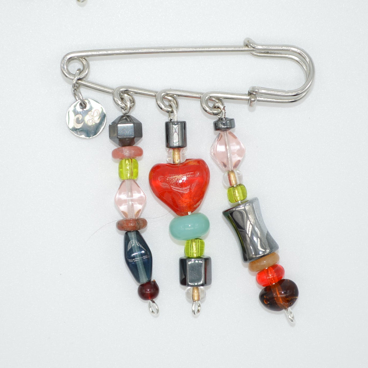 Colorful beaded brooches on a white background