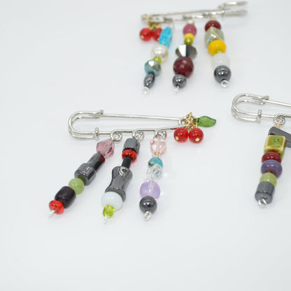 Colorful beaded brooches on a white background