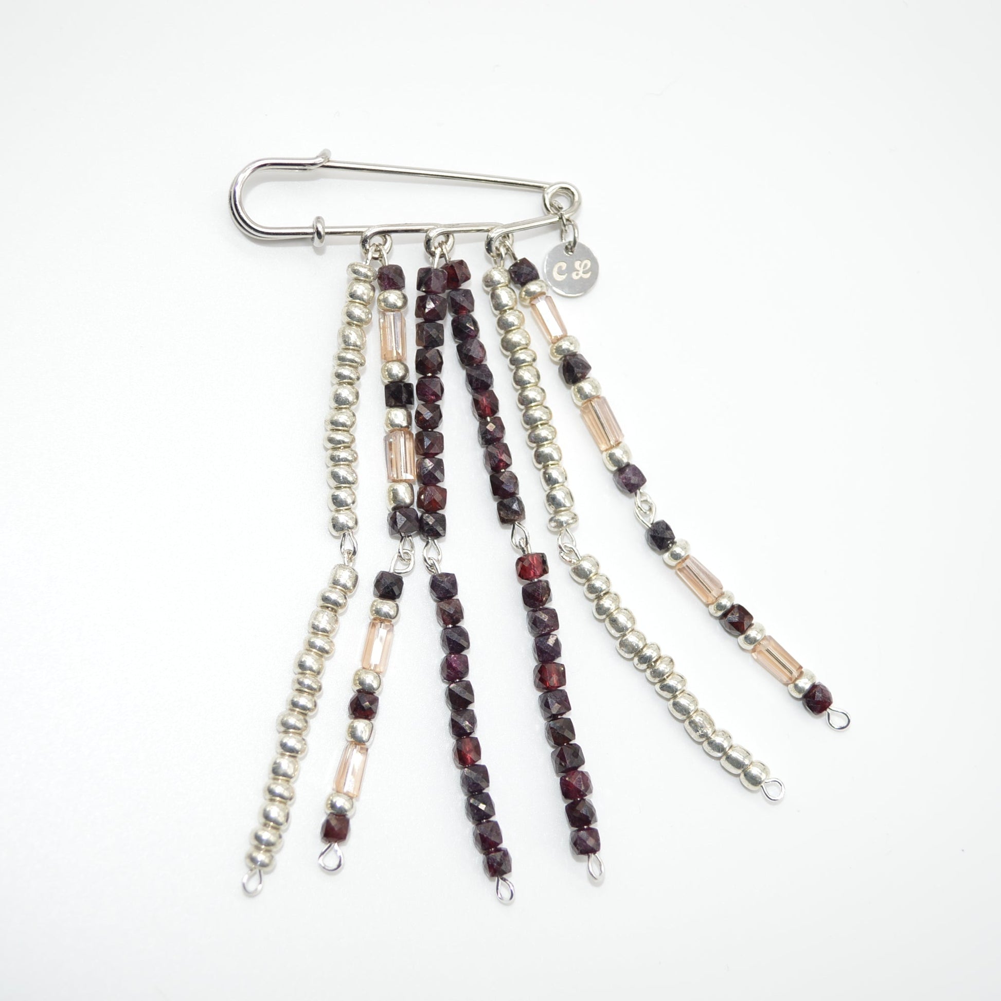 Set of beaded chains with a metal clip on a white background