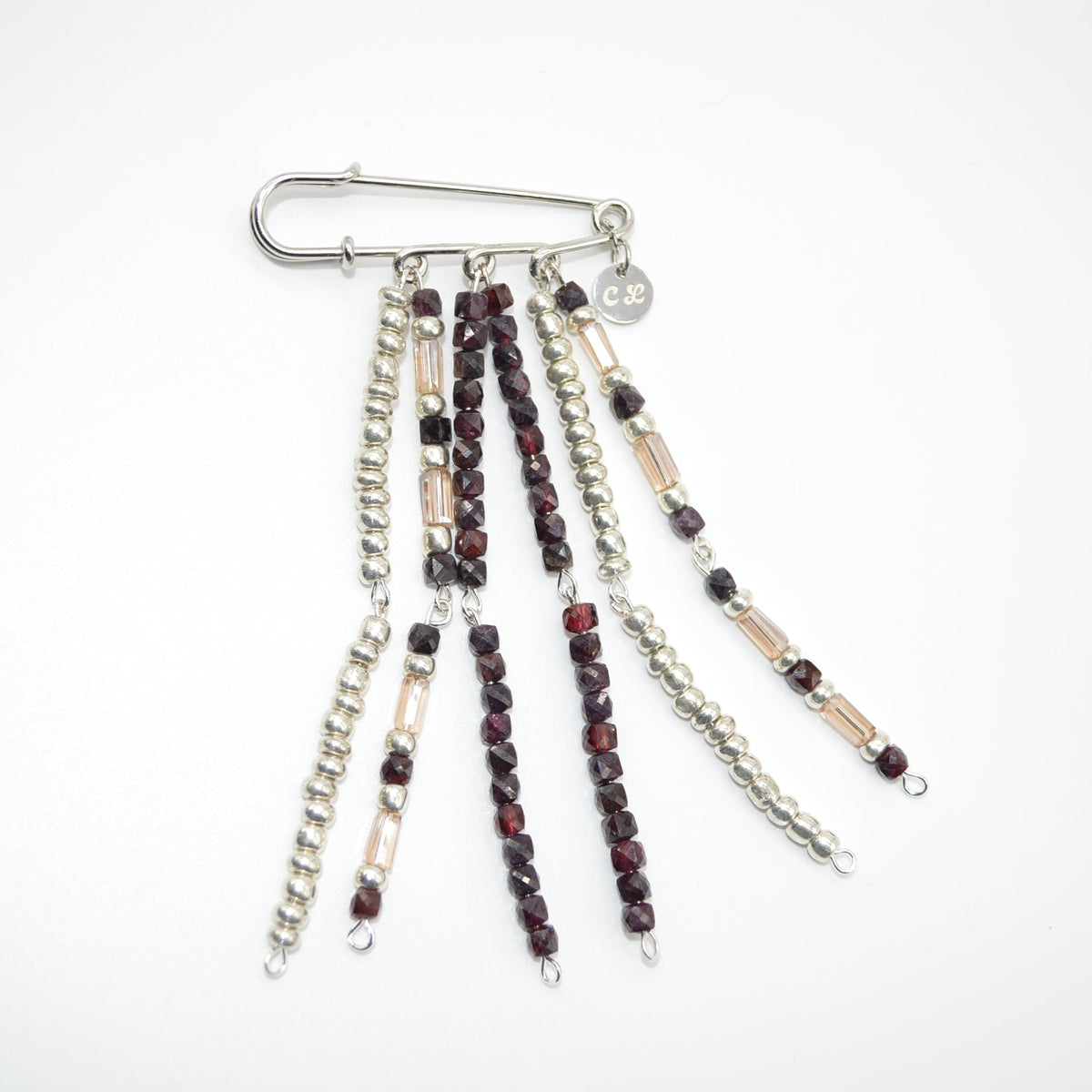 Set of beaded chains with a metal clip on a white background