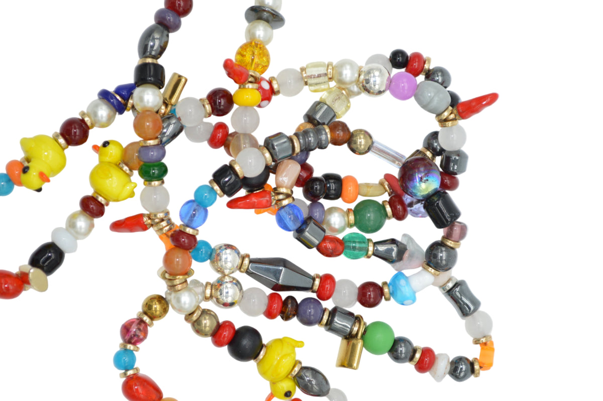 Colorful beaded necklace with various beads on a white background