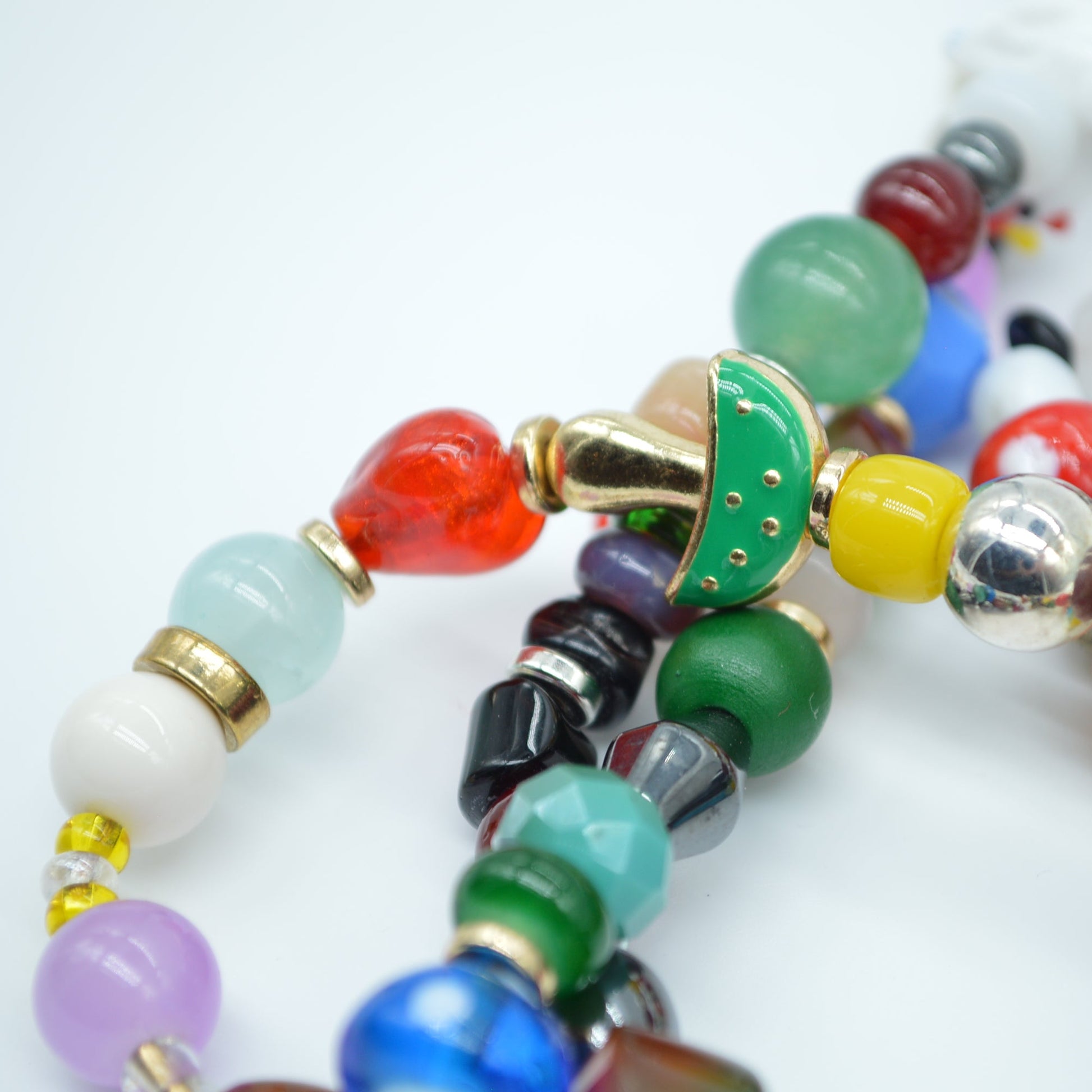 Colorful beaded bracelets on a white background