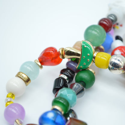 Colorful beaded bracelets on a white background