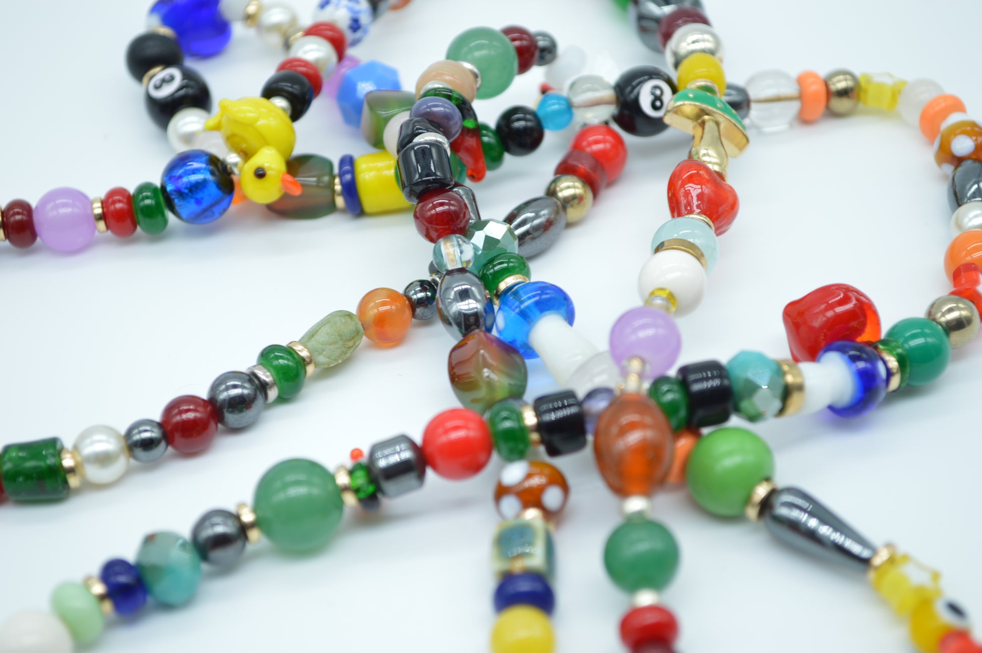 Colorful beaded necklaces on a white background