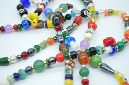 Colorful beaded necklaces on a white background
