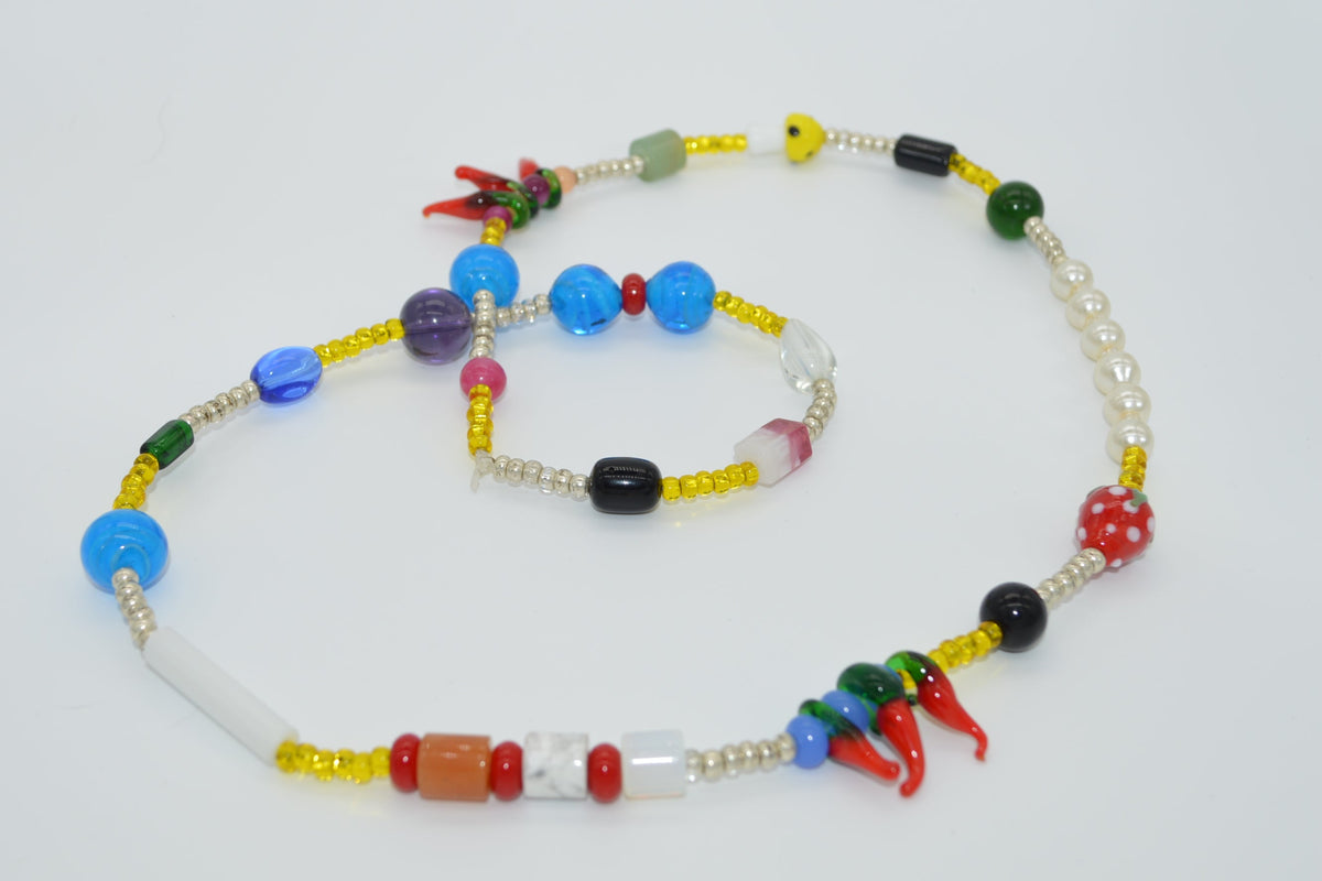 Colorful beaded necklace set on a white background