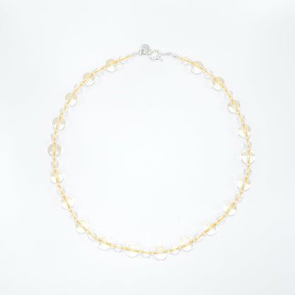 clear and yellow necklace on a white background