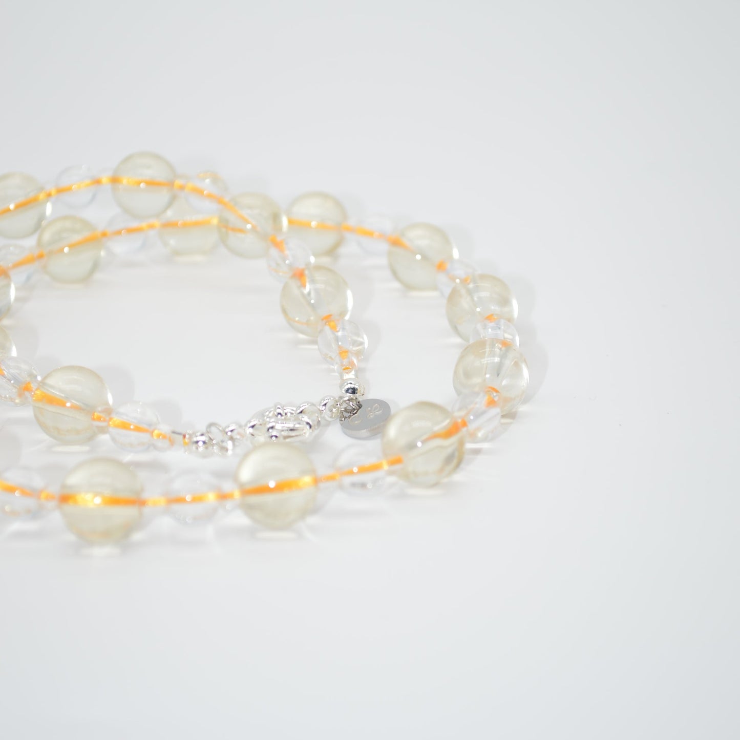 clear and yellow necklace on a white background